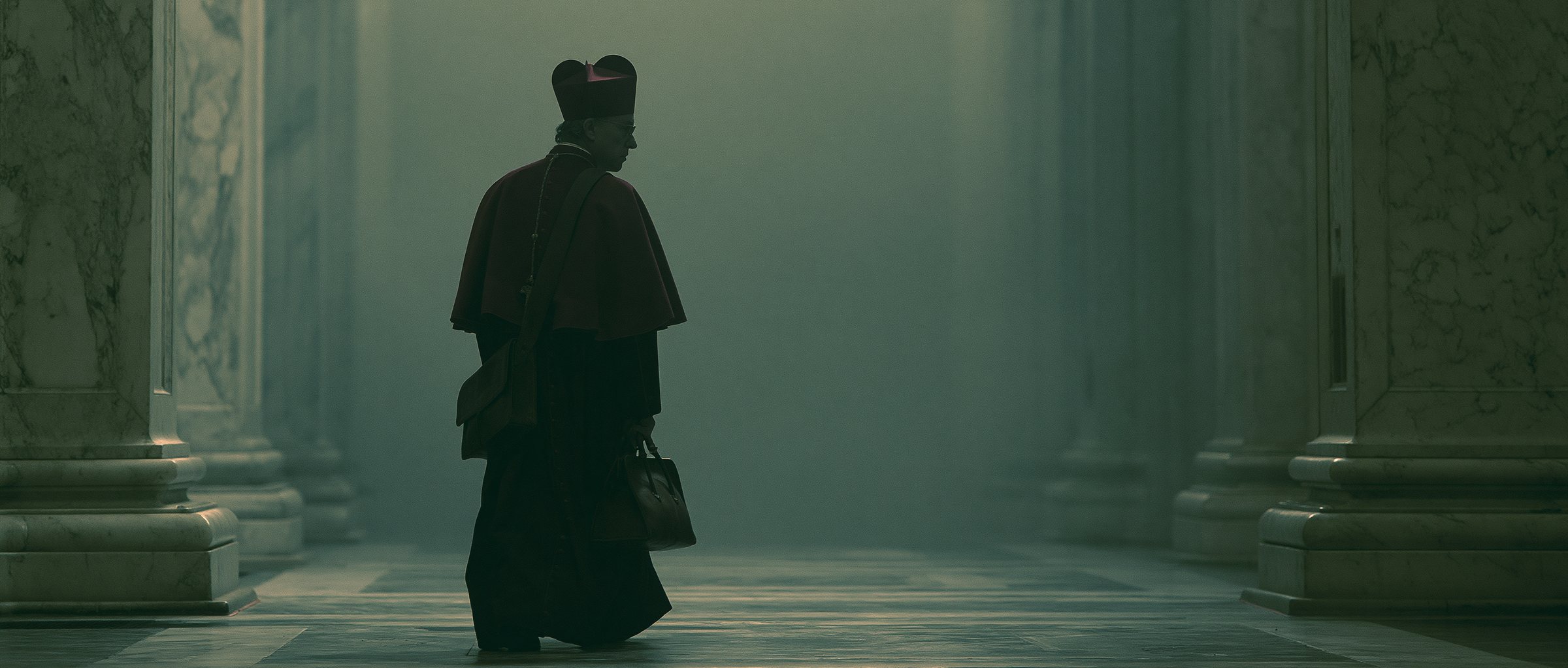 A cardinal walking alone through marble columns with a leather case